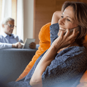 Woman on a phone with a man using smart home devices