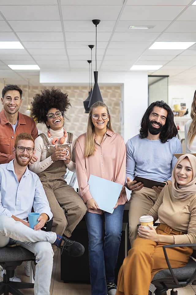 group of peers laughing in a business casual setting