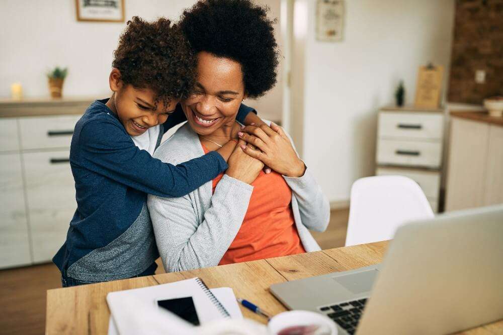 a child hugging their mom from behind