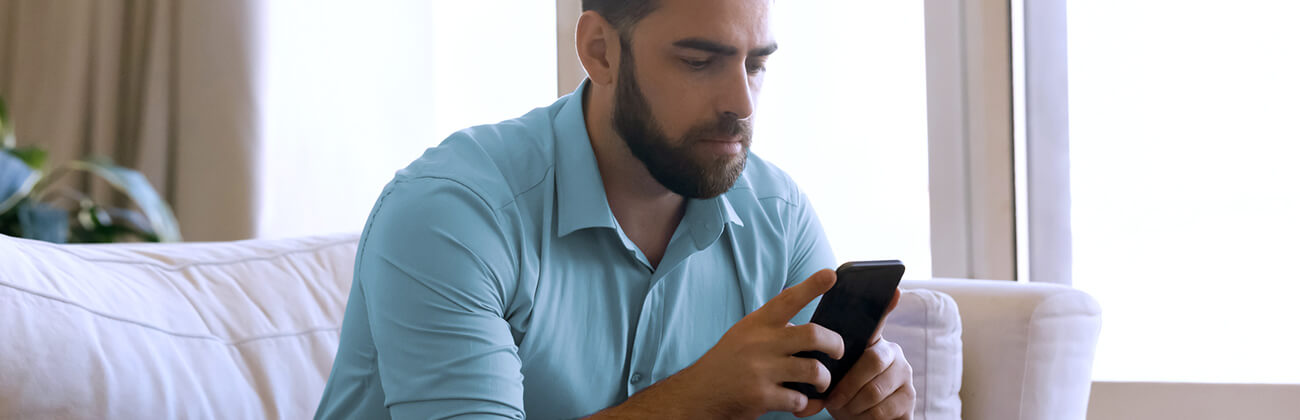 Concerned man checks his mobile settings