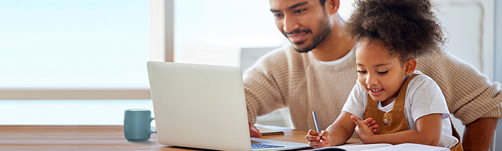 Dad and young daughter work online together