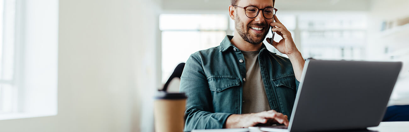 Man conferences on laptop using increased WiFi capabilities